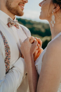 Brautpaar hält sich liebevoll die Hände, Herzenswunsch Hochzeitsplanung